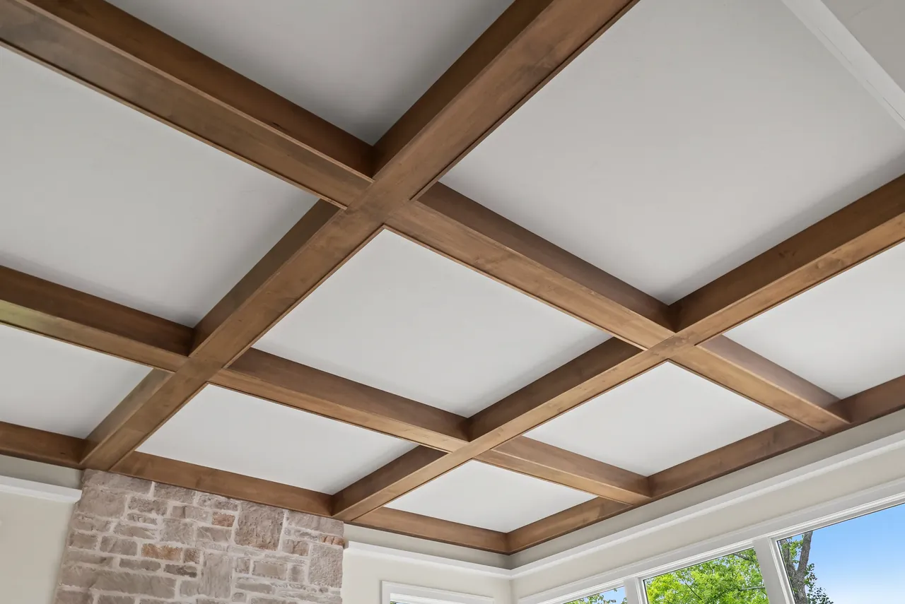 Wood beams forming a geometric pattern across a pale ceiling