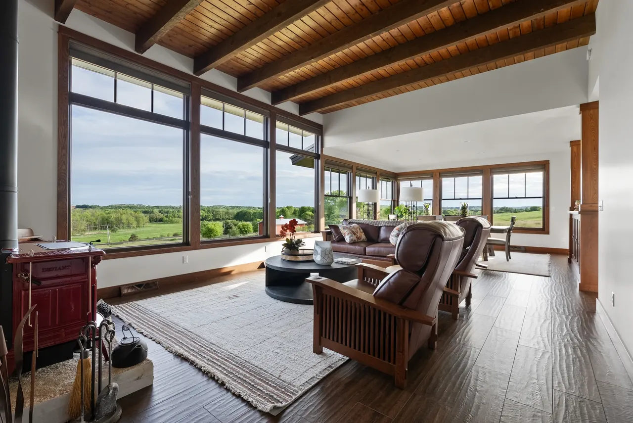 Screened porch with seating and broad views toward the water