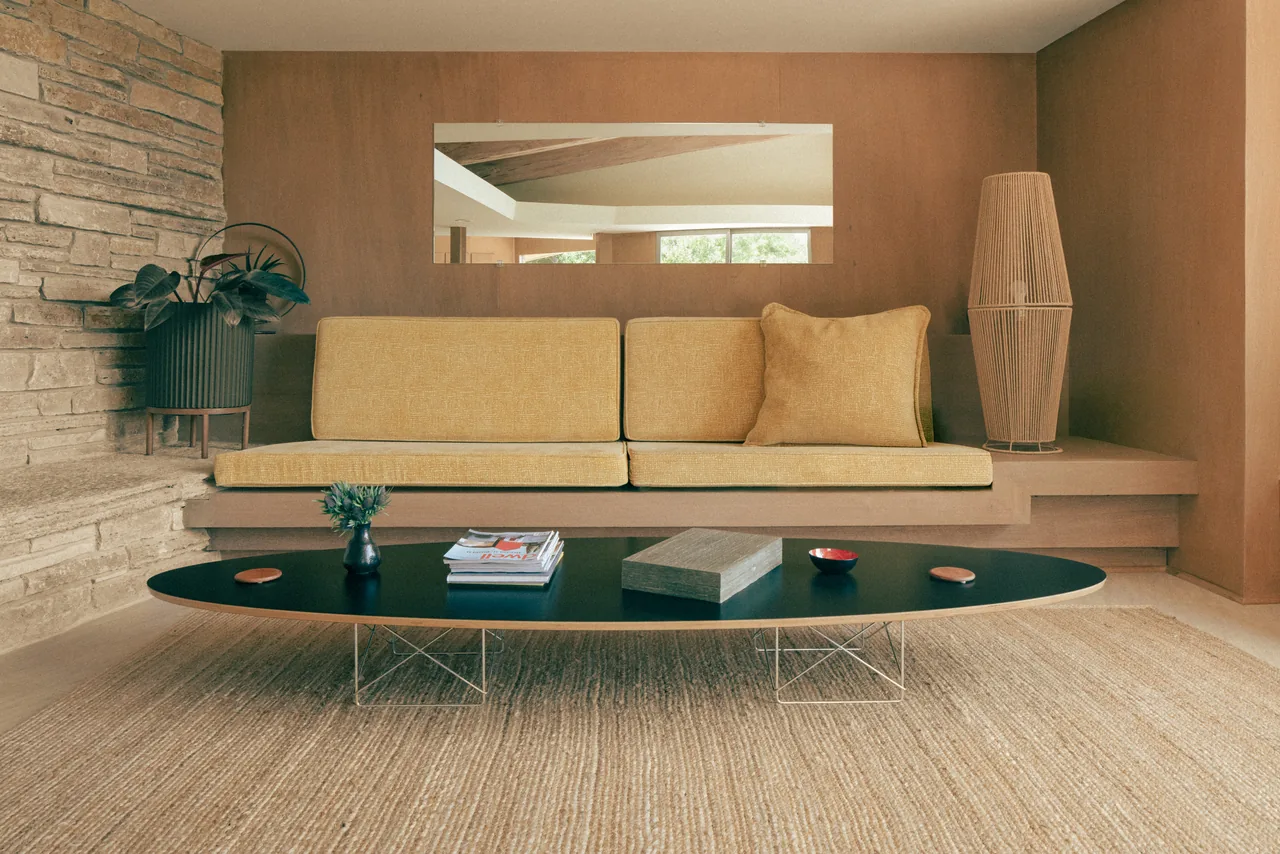 River Hill House interior with gold upholstery, natural stone and wood paneling