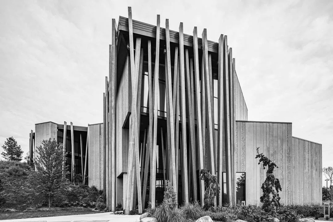 Black-and-white building exterior with angled timber fins
